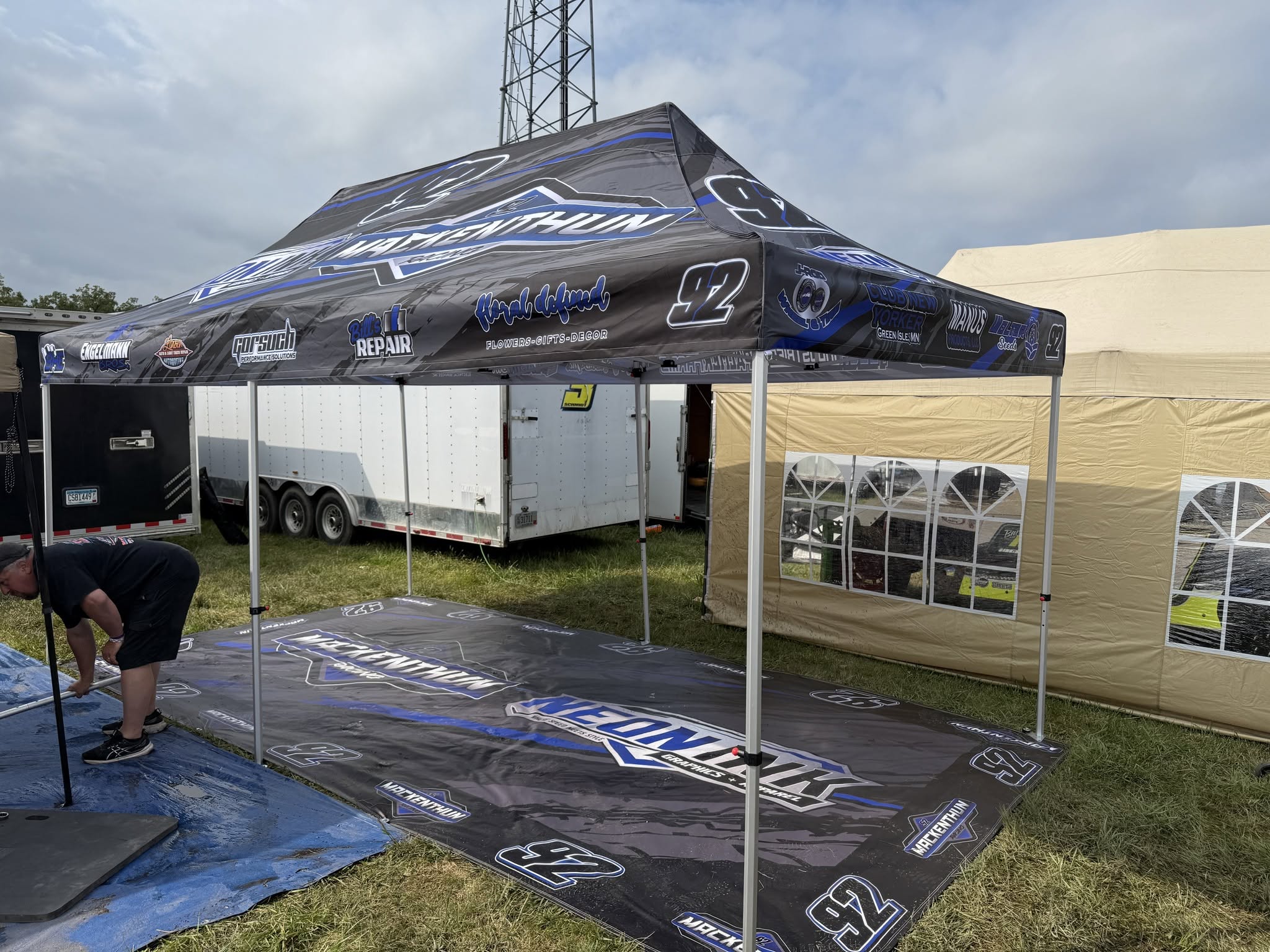 Custom branded event tent and pit mat by Neon Ink