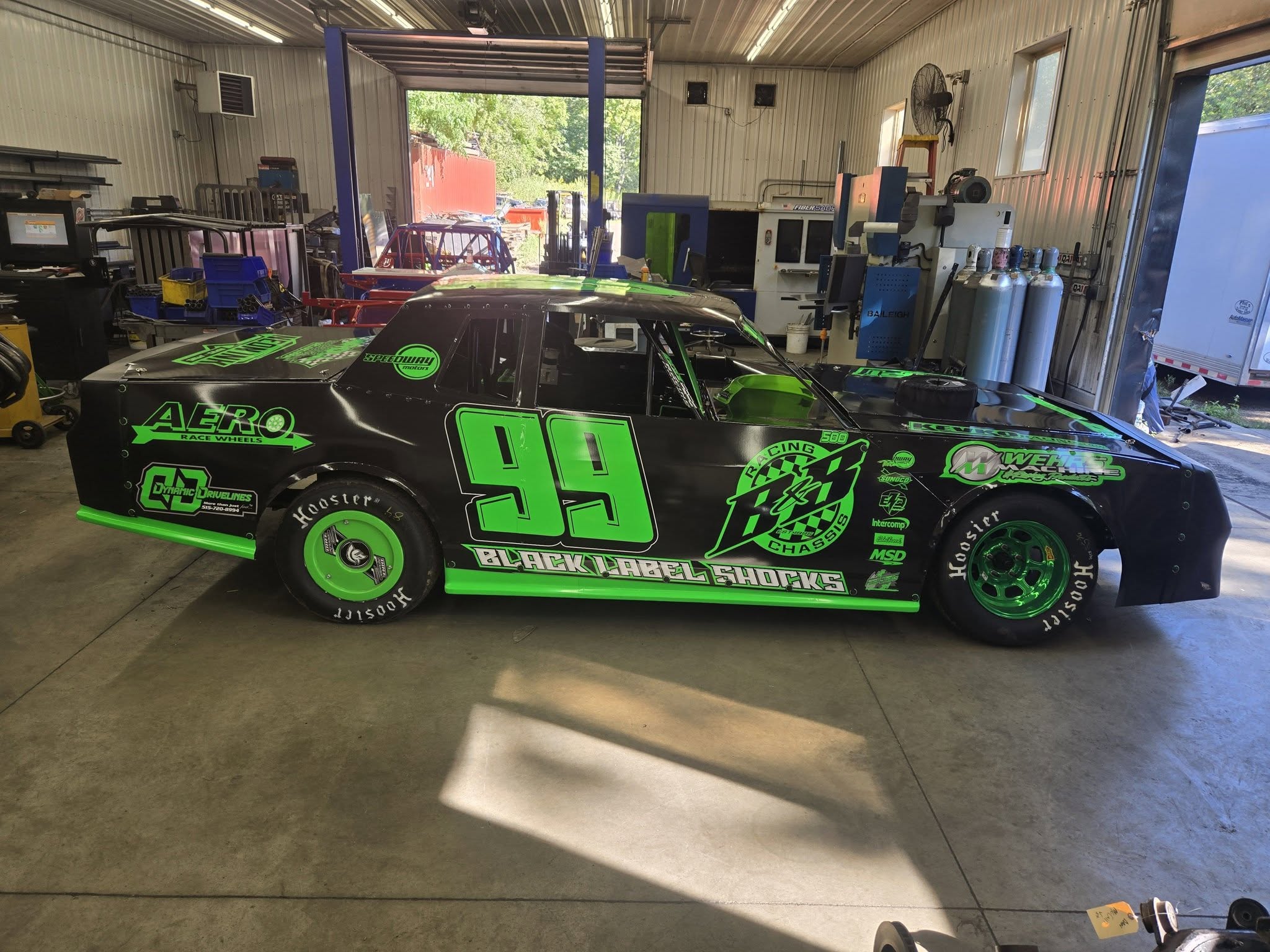 Black and green number 99 race car graphics by Neon Ink
